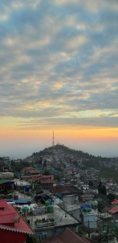 a view of a city with a tower on a hill at SAABY HoMESTAY in Kurseong