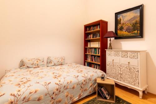 a bedroom with a bed and a book shelf at Exclusive Apartment in Vienna