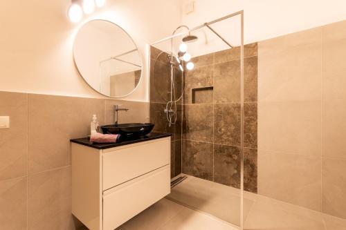 a bathroom with a sink and a mirror at Exclusive Apartment in Vienna
