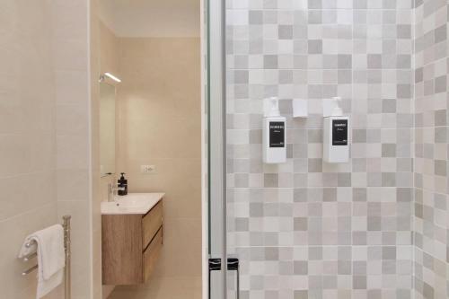 a bathroom with a shower and a sink at Attico con balcone - Mare e Comfort in Lido di Ostia