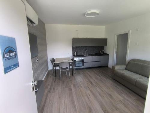 a kitchen and living room with a table and a couch at BEDE-Bike in Casazza