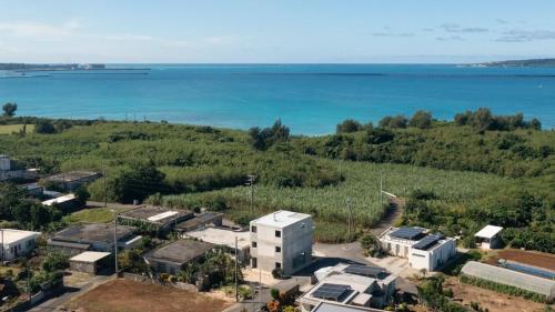 an aerial view of a city and the ocean at villa irifi 夕陽を望むヴィラ in Miyako Island