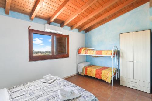 Katil atau katil-katil dalam bilik di Agriturismo Su Nuratolu