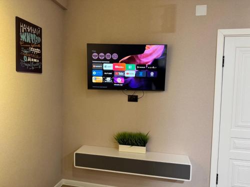 a flat screen tv on the corner of a wall at Tower Apartments in Osh