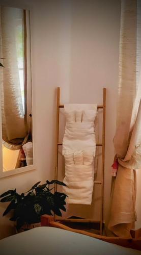 a towel rack with towels on it next to a mirror at Maroudas Traditional Guest House in Vathi