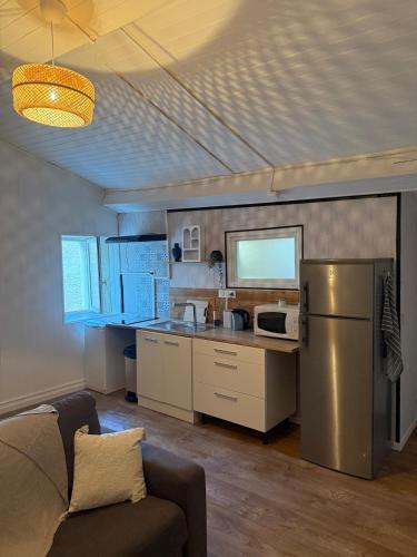 a kitchen with a stainless steel refrigerator and a counter at Grand T2 en centre-ville quartier historique in Fontenay-le-Comte
