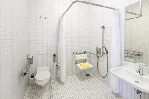 a bathroom with a shower and a toilet and a sink at Jugendherberge Stuttgart Neckarpark in Stuttgart