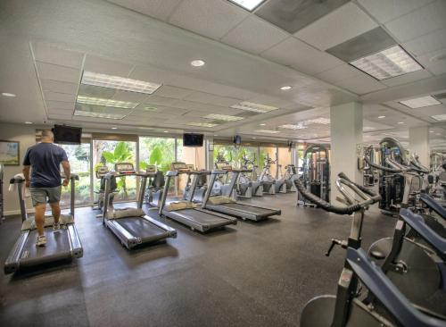 a man standing in a gym with several tread machines at Wyndham Palm-Aire 1BR Apartment with Resort Access in Pompano Beach