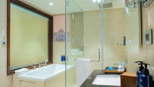 a bathroom with a sink and a shower at Radisson Blu Resort Visakhapatnam in Visakhapatnam