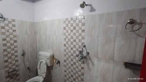 a bathroom with a toilet and a shower at Radha Krishna Home in Varanasi