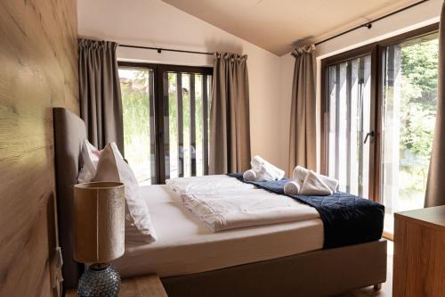 a bedroom with a bed and a large window at Max Relax SUMMERCARD INCLUDED Ski in-ski out in Zell am See