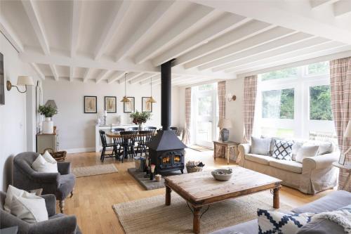 a living room with a wood stove in it at The Coach House, Pentland Hills in Nine Mile Burn