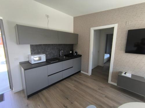 a kitchen with a sink and a microwave at BEDE-Bike in Casazza