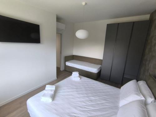 a bedroom with two beds and a flat screen tv at BEDE-Bike in Casazza