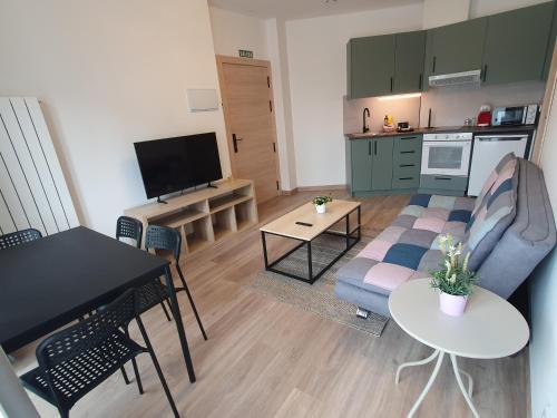 a living room with a couch and a table at Sella Rooms in Arriondas