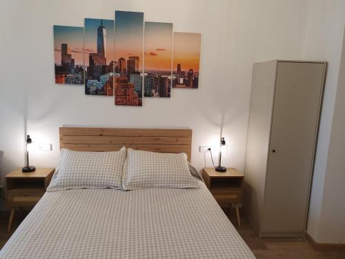 a bedroom with a bed with two nightstands and two lamps at Sella Rooms in Arriondas