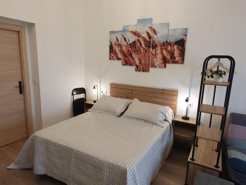 a bedroom with a bed and a ladder in it at Sella Rooms in Arriondas