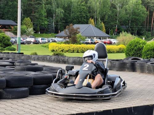 a person riding in a go kart on a pile of tires at Malutkie Resort in Radomsko