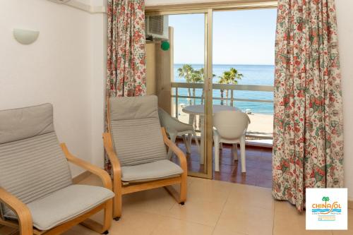 a living room with a view of the ocean at Chinasol Suites in Almuñécar
