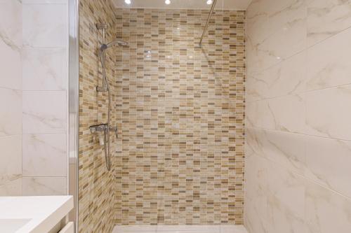 une salle de bain avec une douche avec une porte vitrée dans l'établissement ESPACE 2000 - Beautiful 1BDR with sea view - Swimming pool - AC - Parking, à Menton