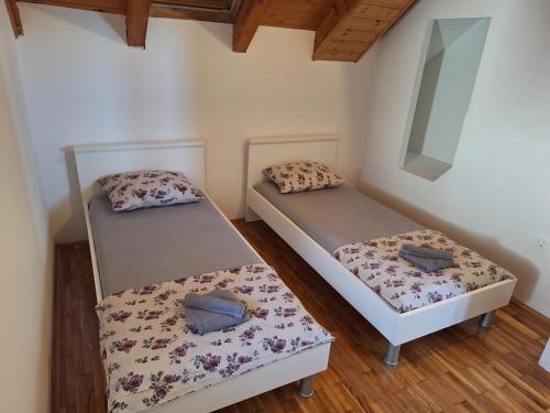 two bunk beds in a room with wooden floors at apartman "Dora" in Rogoznica
