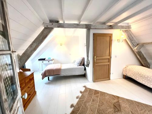a bedroom with two beds in a attic at Les jardins du Tôt in Fermanville