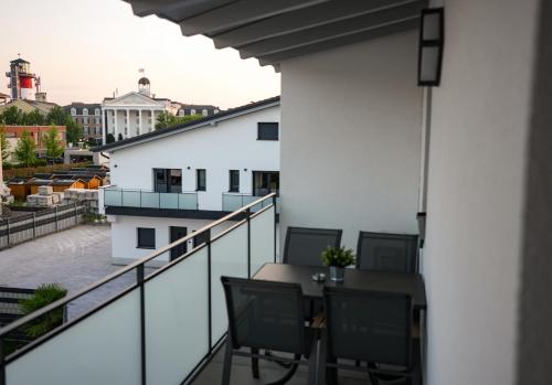 a balcony with a table and chairs on a building at Be Grand Apartments Rust in Rust