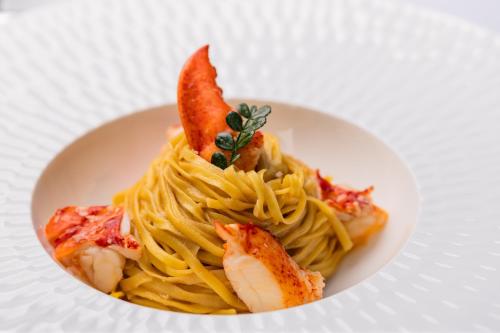 a plate of pasta with shrimp on top of it at Villa Rosa Hotel Desenzano in Desenzano del Garda
