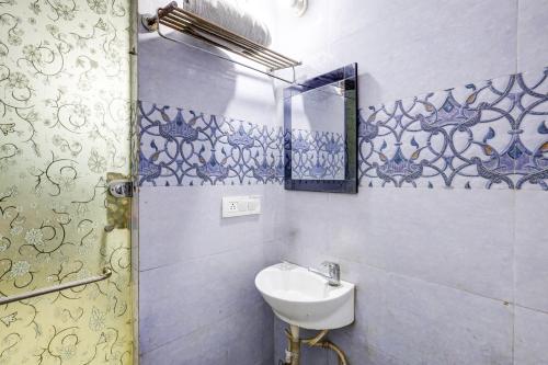 a bathroom with a sink and a mirror at Hotel Hari Nager By The Premium Villa - Mayapur in New Delhi