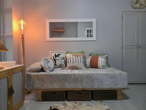 a room with a bed with pillows on it at Ukulala Inn in Malelane