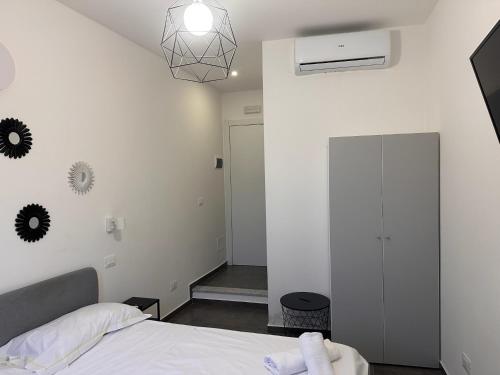 a bedroom with a bed and a white wall at The Vernazza Spot in Vernazza