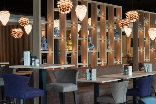 a restaurant with two tables and chairs and lights at Shanghai Hotel Holland in Delft