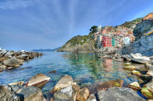 a view of a river with a town on a hill at The Vernazza Spot in Vernazza