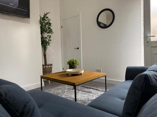 a living room with a blue couch and a coffee table at ResiLets - NEW 3 Bed Apt, Sleeps 5, Town Centre, Ideal for contractors, holidaymakers, Professional Short Stay in Blythe