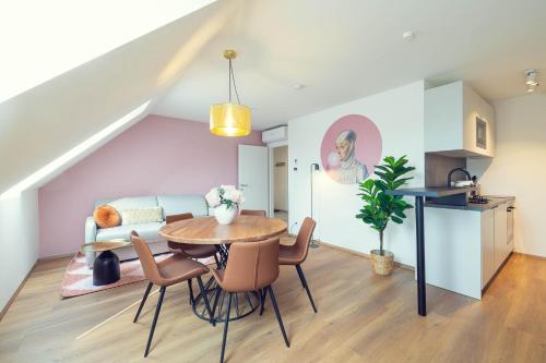 a kitchen and dining room with a table and chairs at LeonArt Living 51 in Graz