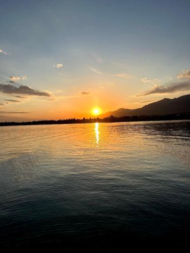 a sunset over a large body of water at Lucky's House in Cholpon-Ata