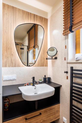 a bathroom with a sink and a mirror at Apartament Panorama M05 by Apart Concept Podhale in Kościelisko
