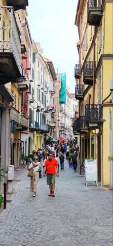 a group of people walking down a city street at Alibi Bed and Beer Apartment in Ivrea