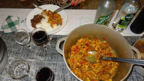 a table with a pot of food and a bowl of rice at Les GREVILLEAS in La Plaine des Cafres