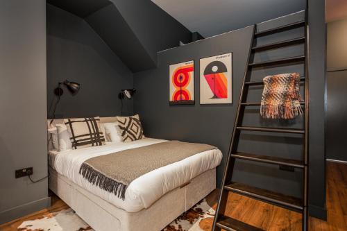 a bedroom with a bed and a ladder at Large Studio Apartment, Free Parking, Close to Centre in Southend-on-Sea