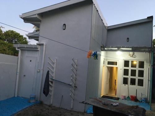 a side view of a house with the door open at White Water Inn in Muli