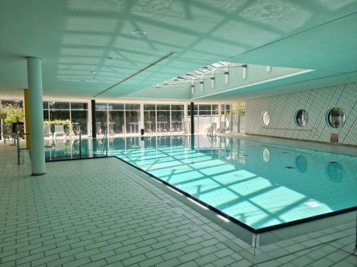 a large swimming pool in a large building at Green Night Hotel in Falkenstein