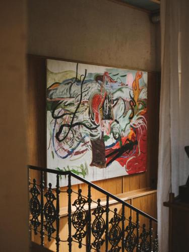 a painting on the wall of a building with a staircase at Bellhop Tbilisi in Tbilisi City
