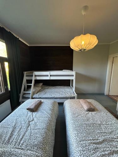 a bedroom with two beds and a bunk bed at Torppari in Kokkola