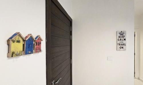 a door in a room with some pictures on the wall at Tabarja Hills apartment in ‘Ayn aş Şughayrah