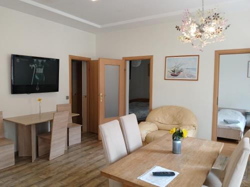 a living room with a table and a dining room at Big apartment in city center in Kaunas