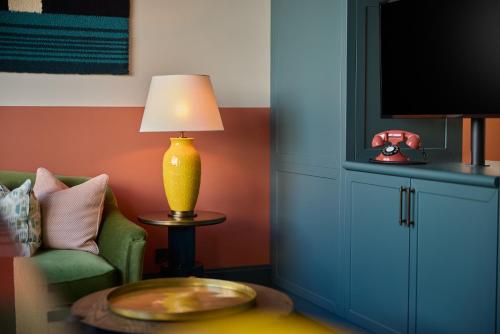 a living room with a couch and a lamp on a table at The July - Boat & Co in Amsterdam