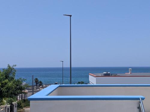 a view of the ocean from a building at Holiday Apartments Azzurro Salento in Torre Vado