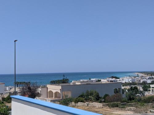 a view of the ocean from the balcony of a house at Holiday Apartments Azzurro Salento in Torre Vado