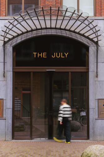 two people walking in front of the julky building at The July - Boat & Co in Amsterdam